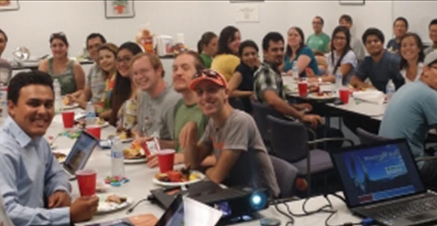 students sitting at multiple tables working on projects